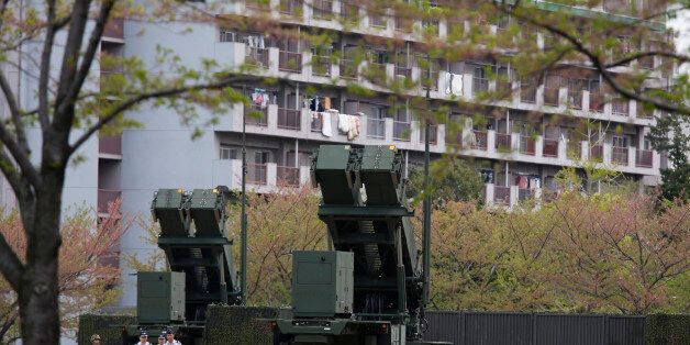 Units of Patriot Advanced Capability-3 (PAC-3) missiles stand in front of a housing complex, at the Defence Ministry in Tokyo April 9, 2013. Japanese public broadcaster NHK showed aerial footage of what it said were ballistic missile interceptors being deployed near Tokyo in response to North Korea's threats and actions. Japan in the past has deployed ground-based PAC-3 interceptors, as well as Aegis radar-equipped destroyers carrying Standard Missile-3 (SM-3) interceptors in the run-up to North Korean missile launches. REUTERS/Issei Kato (JAPAN - Tags: POLITICS MILITARY)
