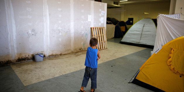 A boy makes his way inside the disused Hellenikon airport where refugees and migrants are temporarily housed in Athens, Greece July 13, 2016. REUTERS/Alkis Konstantinidis
