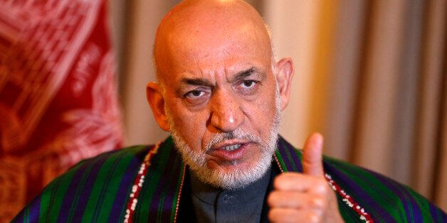 Former Afghan president Hamid Karzai speaks during an interview in Kabul December 25, 2014. Afghanistan's retired president, Karzai, meets his successor almost every day and advises him on key policy issues, he said in an interview, a role that could raise concerns in the West over ties with Kabul. Picture taken December 25, 2014. To match Interview AFGHANISTAN-KARZAI/ REUTERS/Omar Sobhani (AFGHANISTAN - Tags: POLITICS)