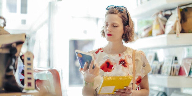 Young fashion designer working in her store