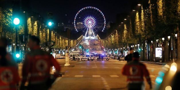 Rescuers walk on the Champs Elysees in Paris after a shooting on April 20, 2017.One police officer was killed and another wounded today in a shooting on Paris's Champs Elysees, police said just days ahead of France's presidential election. France's interior ministry said the attacker was killed in the incident on the world famous boulevard that is popular with tourists. / AFP PHOTO / THOMAS SAMSON (Photo credit should read THOMAS SAMSON/AFP/Getty Images)