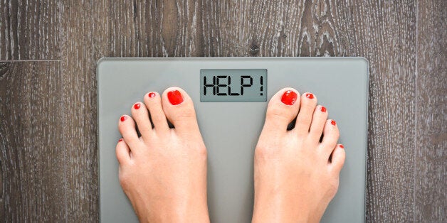 Lose weight concept with person on a scale measuring kilograms