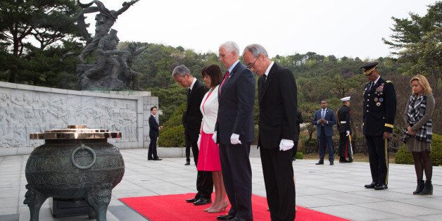 U.S. Vice President Mike Pence, center right, and Second Lady Karen Pence, center left, bow their heads during a visit at the Seoul National Cemetery in Seoul, South Korea, on Sunday, April 16, 2017. North KoreaÂ fired an unidentified ballistic missile on Sunday morning that exploded almost immediately after launch, defying warnings from the Trump administration to avoid any further provocations. Photographer: Lee Young-ho/Pool via Bloomberg