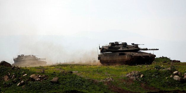 Israeli soldiers take part in a military training in the Israeli-annexed Golan Heights, near the Israel-Syria border on March 22, 2017.Israel seized most of the Golan Heights from Syria in the 1967 Six-Day War and annexed it in 1981, in a move never recognised by the international community. / AFP PHOTO / JALAA MAREY (Photo credit should read JALAA MAREY/AFP/Getty Images)