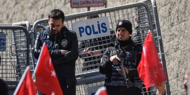 Turkish anti-riot police officers stand guard in front of a police barrier during a demonstration outside the US consulate in Istanbul against the visit of the US Secretary of State on March 30, 2017. US Secretary of State Rex Tillerson was in Ankara on March 30 for talks on the Syria conflict, just a day after Turkey announced that its military offensive was over. Turkey also voiced anger on March 30 after it emerged that the US consulate in Istanbul had contacted a suspect accused of plotting the attempted putsch, who is currently on the run. / AFP PHOTO / OZAN KOSE (Photo credit should read OZAN KOSE/AFP/Getty Images)