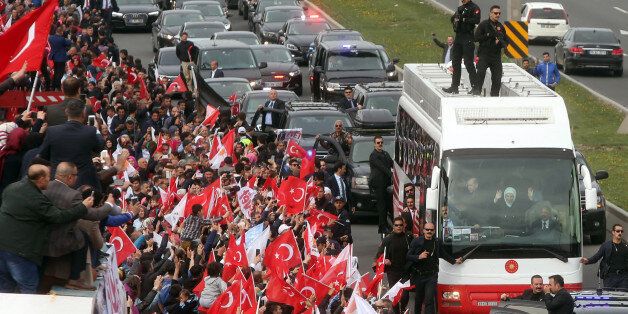 Turkish president Recep Tayyip Erdogan and his wife Emine Erdogan salute supporters from a bus during a parade in Ankara, on April 17, 2017 following the results in a nationwide referendum that will determine Turkey's future destiny.Erdogan on April 17 said Turkey could hold a referendum on its long-stalled EU membership bid after Turks voted to approve expanding the president's powers in a plebiscite. Narrowly won by President Recep Tayyip Erdogan, the referendum asked voters to boost the powers of the Turkish head of state -- a move that rights watchdogs have said could fatally weaken democracy in the linchpin country. / AFP PHOTO / Adem ALTAN (Photo credit should read ADEM ALTAN/AFP/Getty Images)