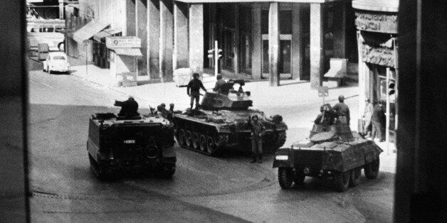 Greek army tanks and soldiers take position in Omnia Place, 27 April 1967, after the military coup of 4 colonels of the Greek army. On 21 April 1967, a group of right-wing army officers led by Brigadier Stylianos Pattakos and Colonels Georgios Papadopoulos and Nikolaos Makarezos seized power in a coup d'etat and installed a military junta, also called 'The Regime of the Colonels, that ended in 1974. (Photo credit should read -/AFP/Getty Images)