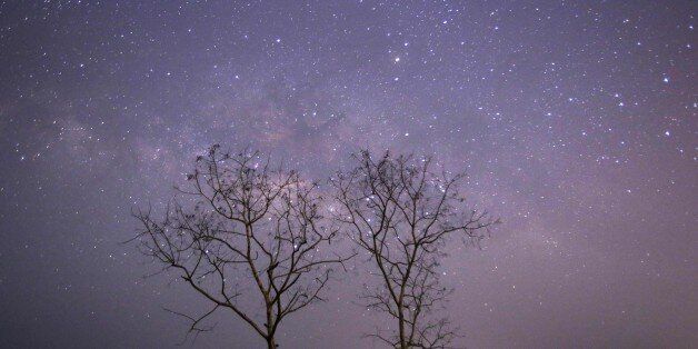 CORRECTION This long-exposure photograph taken on April 23, 2015 on Earth Day shows Lyrids meteors shower passing near the Milky Way in the clear night sky of Thanlyin, nearly 14miles away from Yangon. AFP PHOTO / Ye Aung Thu (Photo credit should read Ye Aung Thu/AFP/Getty Images)