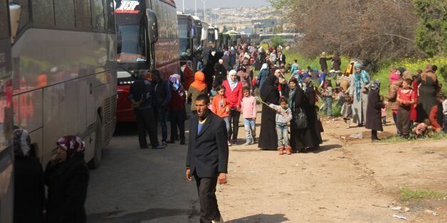 Syrians who arrived a day earlier from government-held villages of Fuaa and Kafraya wait in rebel-held Rashidin, west of Aleppo city, following delays in evacuating them as the hard-won deal ran into trouble on April 15, 2017. / AFP PHOTO / Omar haj kadour (Photo credit should read OMAR HAJ KADOUR/AFP/Getty Images)