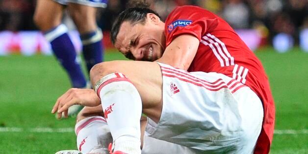TOPSHOT - Manchester United's Swedish striker Zlatan Ibrahimovic reacts after falling awkwardly during the UEFA Europa League quarter-final second leg football match between Manchester United and Anderlecht at Old Trafford in Manchester, north west England, on April 20, 2017. / AFP PHOTO / Oli SCARFF (Photo credit should read OLI SCARFF/AFP/Getty Images)