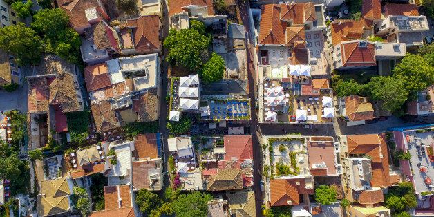 ATHENS, GREECE - MAY 27: Aerial view of Anafiotika on May 27, 2016 in Athens, Greece. Anafiotika is a scenic tiny neighborhood of Athens, part of old historical neighborhood called Plaka. It lies in northerneast side of the Acropolis hill. First houses were built in the era of Otto of Greece when workers from the island of Anafi came to Athens in order to work as constructor workers in the refurbishment of King Othon's Palace.The first two inhabitants were G. Damigos, carpenter and M. Sigalas, c