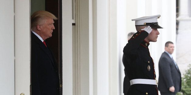 WASHINGTON, DC - MARCH 20: U.S. President Donald Trump (L) waits in the doorway of the West Wing to greet Iraqi Prime Minister Haider al-Abadi for a meeting at the White House, on March 20, 2017 in Washington, DC. (Photo by Mark Wilson/Getty Images)