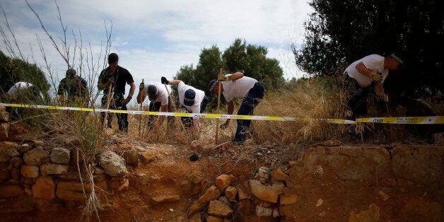 Members of Scotland Yard work at an area during the search for missing British girl Madeleine McCann in Praia da Luz, near Lagos, June 7, 2014. McCann was three when she disappeared from her room at the Praia da Luz holiday resort in the Algarve in May 2007 while her parents were dining with friends at a nearby restaurant, prompting a global hunt and worldwide headlines. REUTERS/Rafael Marchante(PORTUGAL - Tags: SOCIETY CRIME LAW)