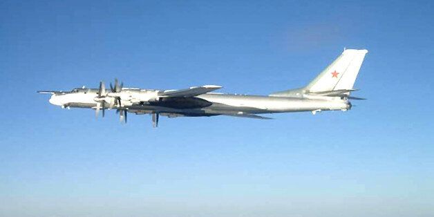In this U.S. Navy handout, one of two Russian Tu-95 Bear long rang bomber aircraft is shown flying near the U.S. Navy aircraft carrier USS Nimitz February 9, 2008 south of Japan. F/A-18 Hornet strike fighters intercepted the bomber and escorted it out of the area. Nimitz was transiting through the Western Pacific on a regularly scheduled deployment when the incident occurred. (Photo by U.S. Navy via Getty Images)