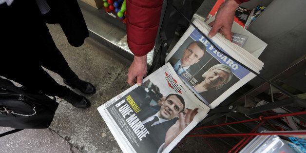 Copies of French daily newspapers with front pages about the results in France's Presidential election are seen in a kiosk in Nice, France, April 24, 2017. REUTERS/Eric Gaillard