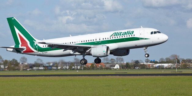 Amsterdam, The Netherlands - May 7, 2015: An Airbus A320-216 of Alitalia lands at Amsterdam Airport Schiphol (The Netherlands, AMS) on May 7, 2015. The name of the runway is Polderbaan.