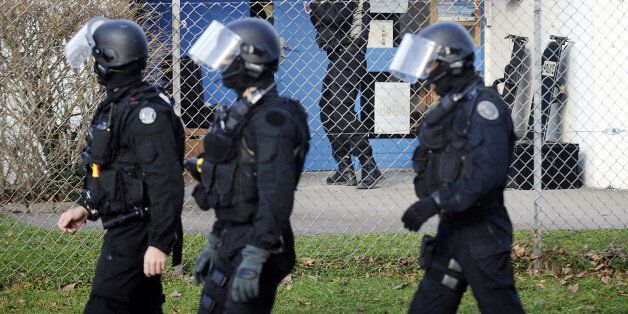 Members of French National Police Intervention Groups forces (GIPN) get ready near a nursery school where a sword-wielding teenager was holding five or six children on December 13, 2010 in Besancon, eastern France. It was not immediately clear if the 17-year-old hostage taker had surrendered to security forces at the school. The youth armed with two swords earlier burst into the school and took 20 children hostage before later releasing most of them. AFP PHOTO JEFF PACHOUD (Photo credit should read JEFF PACHOUD/AFP/Getty Images)