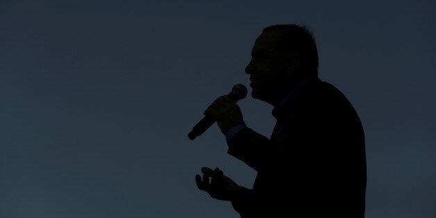 Turkish President Tayyip Erdogan is silhouetted as he addresses his supporters during a rally for the upcoming referendum in Istanbul, Turkey, April 15, 2017. REUTERS/Huseyin Aldemir