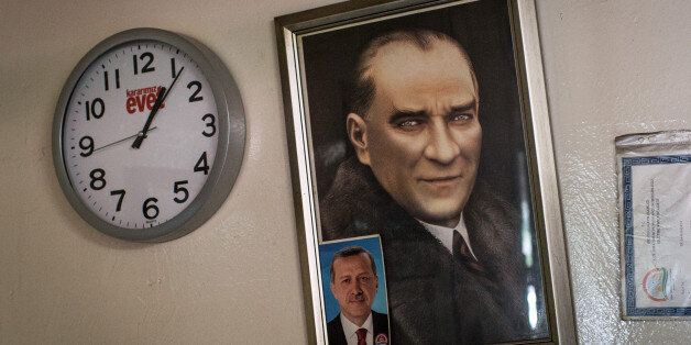 ISTANBUL, TURKEY - APRIL 16: Portraits of Mustafa Kemal Ataturk and Turkish President Recep Tayyip Erdogan are seen next to an 'Evet' (Yes) clock on a wall of a teahouse on April 16, 2017 in Istanbul, Turkey. Constitutional referendum voting opened across Turkey after months of intense campaigning by both the 'Evet'(Yes) and 'Hayir' (No) camps. Turks are voting on 18 proposed amendments to the Constitution of Turkey. The controversial changes seek to replace the parliamentary system and move to a presidential system, which would give President Recep Tayyip Erdogan executive authority. (Photo by Chris McGrath/Getty Images)