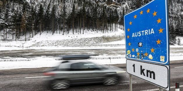 A car passes a street sign reading 'Austria' in the Italian village of Brenner on the Italian - Austrian boarder, March 3, 2016. REUTERS/Dominic Ebenbichler