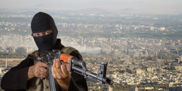 Actor posing as a terrorist. The image is a collage. Image of a man superimposed on the image of one of the districts of Damascus.