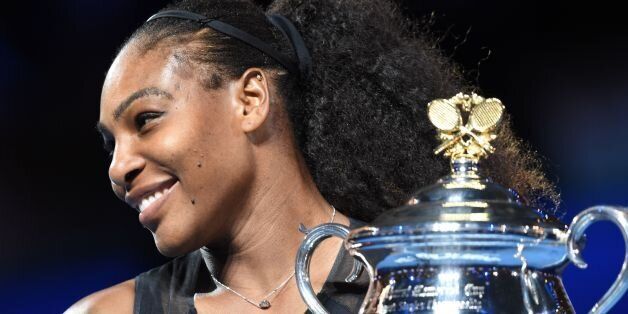 Serena Williams of the US holds up the trophy following her victory over Venus Williams of the US in the women's singles final on day 13 of the Australian Open tennis tournament in Melbourne on January 28, 2017. / AFP / PAUL CROCK / IMAGE RESTRICTED TO EDITORIAL USE - STRICTLY NO COMMERCIAL USE (Photo credit should read PAUL CROCK/AFP/Getty Images)