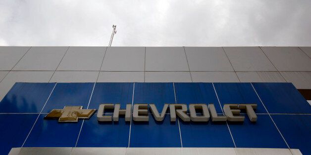 The Chevrolet logo is seen at the top of a closed branch in Caracas January 30, 2015. At least 40 major U.S. companies have substantial exposure to Venezuela?s deepening economic crisis, and could collectively be forced to take billions of dollars of write downs, a Reuters analysis shows. The companies, all members of the S&P 500, and including some of the biggest names in Corporate America such as autos giant General Motors and drug maker Merck & Co Inc, together carry at least $11 billion of monetary assets in the Venezuelan currency, the bolivar, on their books. Picture taken January 30. To match Insight VENEZUELA-USA/CORPORATIONS REUTERS/Carlos Garcia Rawlins (VENEZUELA - Tags: BUSINESS TRANSPORT LOGO)