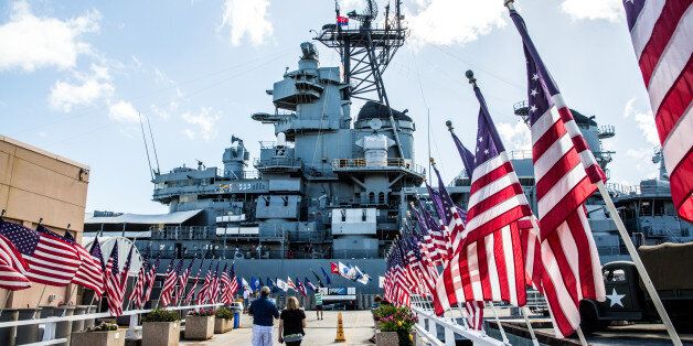 Tourist walk to the USS Missouri Memorial, the Mighty Mo, berthed at Pearl Harbor Hawaii, Island of Oahu. September 2 commemorates the 1945 formal surrender of Japan to Allied Forces ending WWII on the deck of the Battleship in Tokyo Bay