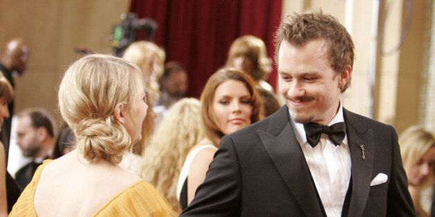 Best supporting actress nominee Michelle Williams (L) walks the red carpet with her fiance and best actor nominee Heath Ledger (R) at the 78th annual Academy Awards at the Kodak Theatre in Hollywood, California, March 5, 2006. Both are nominated for their roles in