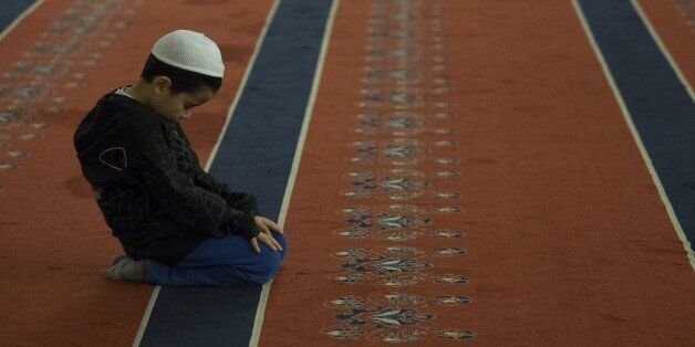 ANKARA, TURKEY - MARCH 30: A Muslim boy performs prayers at Kocatepe Mosque during the Lailat al Regaip, the holy night which marks the start of the holy months of Rajab, Shaban and Ramadan, in Ankara, Turkey on March 30, 3017. (Photo by Gokhan Balci/Anadolu Agency/Getty Images)