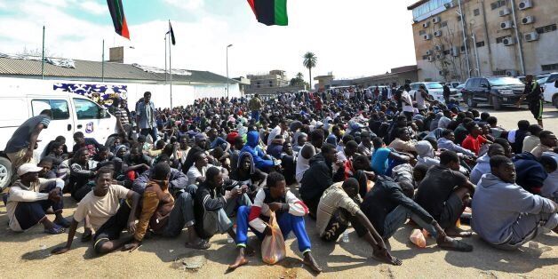 African migrants gather at the Tripoli branch of the Anti-Illegal Immigration Authority, in the Libyan capital on March 23, 2017. / AFP PHOTO / MAHMUD TURKIA (Photo credit should read MAHMUD TURKIA/AFP/Getty Images)