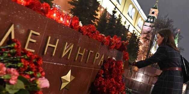A woman lays flowers in memory of victims of the blast in the Saint Petersburg metro at a memorial stone reading Leningrad by the Kremlin wall in central Moscow on April 3, 2017.Russia opened a probe into a suspected 'act of terror' Monday after 10 people were killed and dozens more injured in a blast that rocked the Saint Petersburg metro. / AFP PHOTO / Vasily MAXIMOV (Photo credit should read VASILY MAXIMOV/AFP/Getty Images)