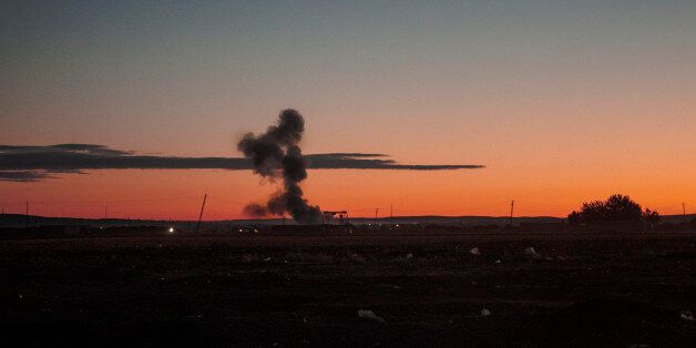 Exploding mushroom bomb at sunset on blue sky in Syria, Kobani war