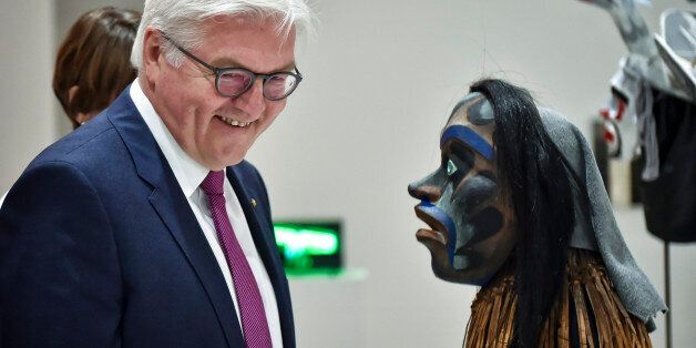 German President Frank-Walter Steinmeier (L) looks at a mask by Kwakwaka'wakw (or Kwakiutl) artist Beau Dick, during the official opening of the Documenta 14 international art exhibition, at the National Museum of Contemporary Art (EMST) in Athens on April 8, 2017.One of the world's premier art events opened in Athens on April 8, 2017 bringing a much-needed spotlight, artistic inspiration and visitor boost to crisis-hit Greece's run-down capital. Documenta 14, the contemporary art exhibition held every five years in Kassel, Germany, puts over 160 international artists on display across the city in over 40 public institutions, squares, cinemas, university campuses and libraries, showcasing painting, performances, sculpture and sound art. / AFP PHOTO / LOUISA GOULIAMAKI / RESTRICTED TO EDITORIAL USE - MANDATORY MENTION OF THE ARTIST UPON PUBLICATION - TO ILLUSTRATE THE EVENT AS SPECIFIED IN THE CAPTION (Photo credit should read LOUISA GOULIAMAKI/AFP/Getty Images)