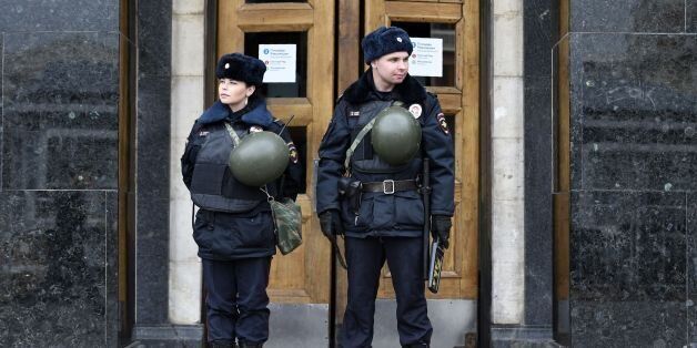 Russian police officers stand guard at the entrance to Ploschad Revolyutsii metro station on April 4, 2017 in Moscow, as security measures are tightened following the blast in the Saint Petersburg metro. / AFP PHOTO / Yuri KADOBNOV (Photo credit should read YURI KADOBNOV/AFP/Getty Images)