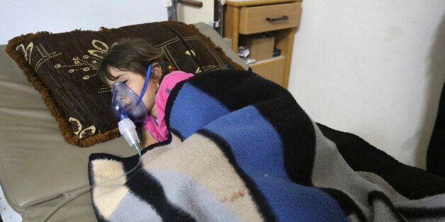 A girl, affected by what activists say was a gas attack, receives treatment inside a makeshift hospital in Kfar Zeita village in the central province of Hama May 22, 2014. Syrian opposition activists have posted a video of what they say is chlorine gas floating through the streets of the village, the first such footage of an alleged chemical weapon campaign by President Bashar al-Assad. The village of Kfar Zeita, in the central province of Hama 125 miles (200 km) north of Damascus, has been the epicentre of what activists and medics say is two-month-long assault in which chlorine gas canisters are dropped out of helicopters. Picture taken May 22. To match story SYRIA-CRISIS/CHLORINE REUTERS/Badi Khlif (SYRIA - Tags: POLITICS CIVIL UNREST CONFLICT HEALTH TPX IMAGES OF THE DAY)