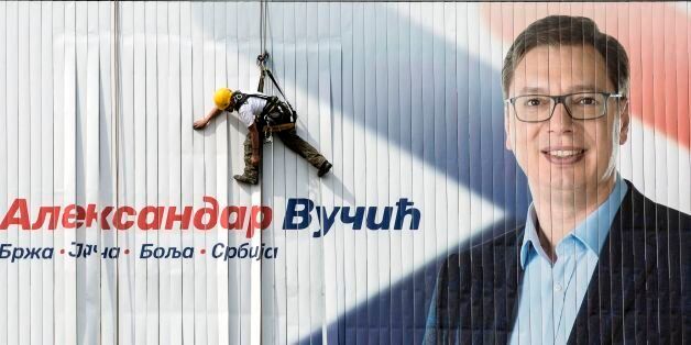 A worker installs on a wall an electoral poster of the Serbian Progressive Party (SNS) top candidate for the presidential election and Serbian Prime Minister Aleksandar Vucic in Belgrade on March 23, 2017. Serbia's strongman Aleksandar Vucic hopes to win presidential elections in the first round on April2, 2017, to strengthen his political power despite criticism from divided opposition accusing him of authoritarianism. / AFP PHOTO / OLIVER BUNIC (Photo credit should read OLIVER BUNIC/AFP/Getty Images)