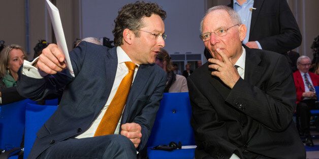 Jeroen Dijsselbloem, Dutch finance minister and head of the group of euro-area finance ministers, left, chats with Wolfgang Schaeuble, Germany's finance minister, before a news conference at the finance ministry in Berlin, Germany, on Monday, April 4, 2016. Greece could again face the threat of being pushed into default and out of the euro if its current bailout review drags on into June and July, according to European officials monitoring the slow progress of Prime Minister Alexis Tsipras's negotiations with creditors. Photographer: Rolf Schulten/Bloomberg via Getty Images