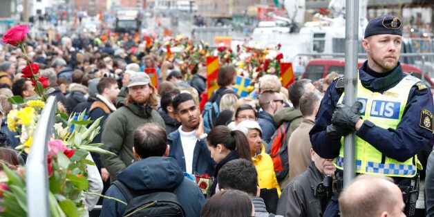 People gather at a makeshift memorial near the scene where a truck slammed the day before into a crowd of people outside a busy department store in central Stockholm, on April 8, 2017. / AFP PHOTO / Odd ANDERSEN (Photo credit should read ODD ANDERSEN/AFP/Getty Images)