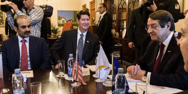 Cyprus President Nicos Anastasiades (R) sits next to Andrew Swiger, Senior Vice President of ExxonMobil Corporation (C) and Saad Sherida Al-Kaabi, President and CEO Qatar Petroleum (L), in the presidential palace in Nicosia on April 05,2017.US giant ExxonMobil with Qatar Petroleum signed a licence to explore for oil and gas off the coast of Cyprus and they expect to start drilling next year. The venture was selected as part of the islands third licensing round to explore block 10. / AFP PHOTO / Iakovos Hatzistavrou (Photo credit should read IAKOVOS HATZISTAVROU/AFP/Getty Images)