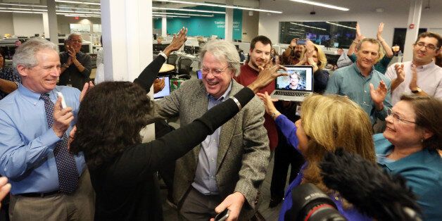 The Miami Herald newsroom reacts to the second of two Pulitzer Prize awards announced on Monday, April 10, 2017. Nancy Ancrum, editorial page editor, reaches to give Jim Morin, political cartoonist, a hug for his second career Pulitzer. (Emily Michot/Miami Herald/TNS via Getty Images)