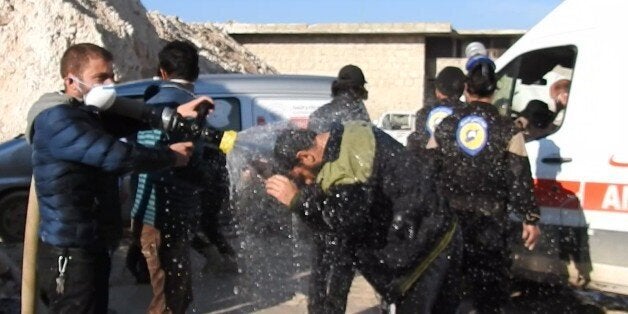 reduce the effectIDLIB, SYRIA - APRIL 4: Civil defense members try to reduce the effects of chlorine gas with water as they carry out search and rescue works after Assad Regime forces's attack with chlorine gas to Khan Shaykhun town of Idlib, Syria on April 4, 2017. (Photo by Firas Faham/Anadolu Agency/Getty Images)