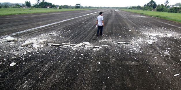 A man walks past the damaged runway of the dometic airport after a 6.5-magnitude earthquake struck overnight in Surigao City in southern island of Mindanao on February 11, 2017. A strong quake shook the southern Philippines on February 10, killing at least three people, toppling buildings and sending panicked residents fleeing their homes, media reports and authorities said. / AFP / ERWIN MASCARINAS (Photo credit should read ERWIN MASCARINAS/AFP/Getty Images)