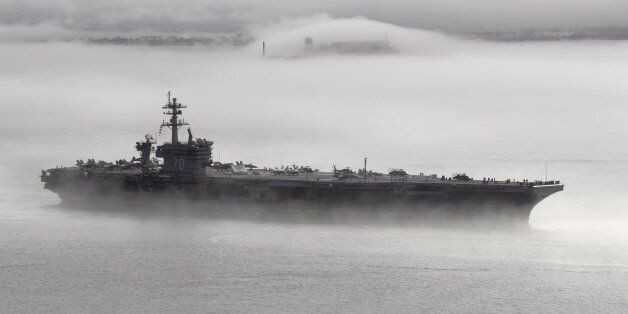 [UNVERIFIED CONTENT] October 11, 2011 - the aircraft carrier USS Carl Vinson (CVN-70) leaves the San Francisco Bay on a foggy morning, a couple of days after Fleet Week 2011 in San Francisco. Alcatraz Island can be seen in the background, partially hidden by fog.