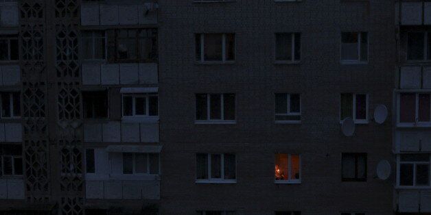 A single light illuminates a room during a blackout at a residential building in Simferopol, Crimea November 24, 2015. Crimea continued to rely on emergency generators to meet its basic power needs after unknown saboteurs blew up electricity pylons supplying the peninsula with electricity over the weekend. REUTERS/Pavel Rebrov TPX IMAGES OF THE DAY