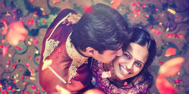 Young indian just married couple after weddind ceremony. Young happy family.Indian groom and bride in traditional wedding dress.