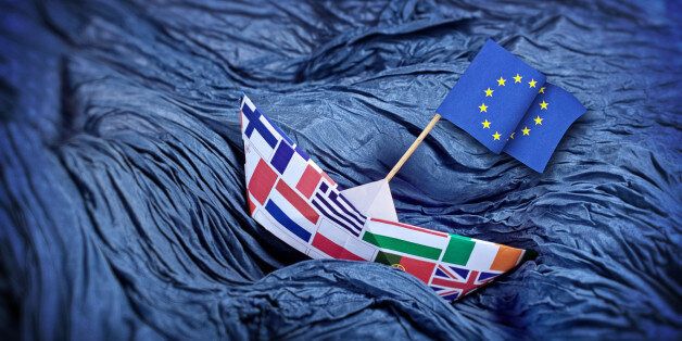 The EU paper boat over troubled water. Waves made of blue wrinkled fabric.