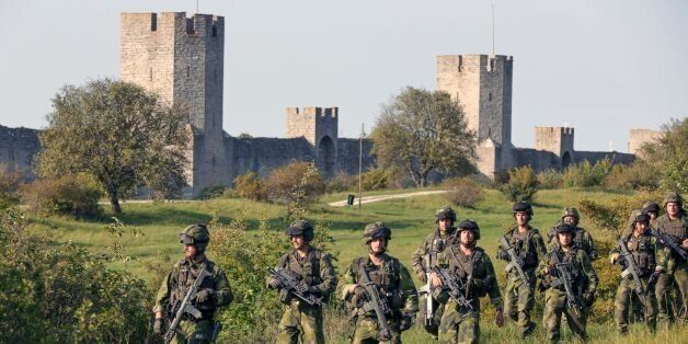 A squad from Skaraborg Armoured Regiment patrol outside Visby's 13th century city wall in Sweden on September 14, 2016. Sweden's Baltic Sea island of Gotland is once again home to a permanent military presence, the military said, amid speculation over the country's ability to defend itself against a more assertive Russia. / AFP / TT NEWS AGENCY AND TT News Agency / SOREN ANDERSSON / Sweden OUT (Photo credit should read SOREN ANDERSSON/AFP/Getty Images)