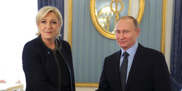 Russian President Vladimir Putin shakes hands with Marine Le Pen, French National Front (FN) political party leader and candidate for the French 2017 presidential election, during their meeting in Moscow, Russia March 24, 2017. Sputnik/Mikhail Klimentyev/Kremlin via REUTERS ATTENTION EDITORS - THIS IMAGE WAS PROVIDED BY A THIRD PARTY. EDITORIAL USE ONLY.
