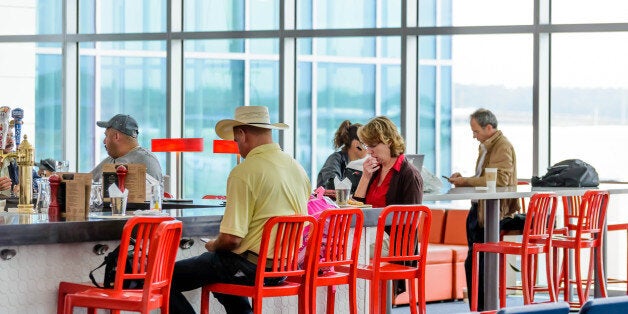 Houston, TX, USA - September 14, 2014: IAH, Houston Intercontinental Airport, Houston, TX, USA - people seated at restaurant bar in an airport